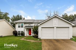 Indianapolis house for rent - a white house with a red door and a white garage