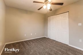 Indianapolis house for rent - the ceilings in this spacious bedroom are lightened by the ceiling fan and the door