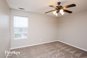 Dawsonville house for rent - a bedroom with a ceiling fan and a window