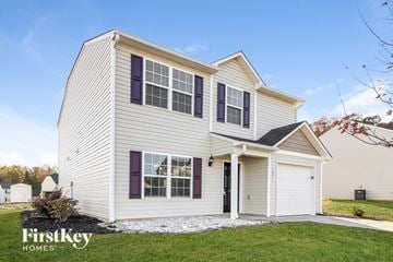 Lexington house for rent - a white house with purple window shutters and a white garage