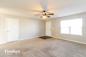 Lexington house for rent - a living room with carpet and a ceiling fan