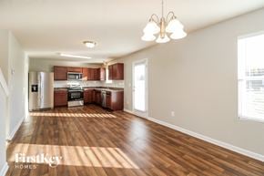 Lexington house for rent - a kitchen and living room with wood flooring in an empty house