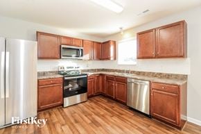 Lexington house for rent - a kitchen with wooden cabinets and stainless steel appliances