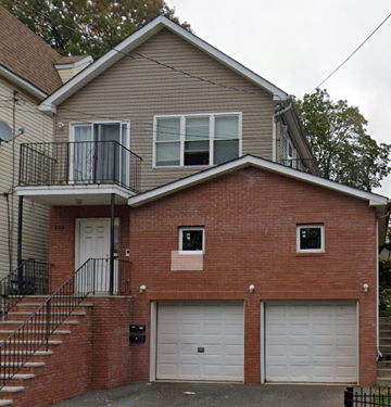 Irvington apartment for rent - A two-story house with a balcony on the upper floor.