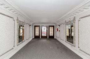 San Francisco apartment for rent - A long hallway with white walls and a grey floor.