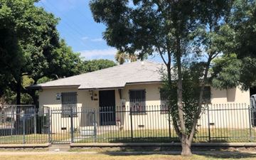 San Bernardino apartment for rent - a house with a fence and a tree in front of it
