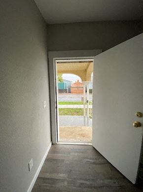 Colton apartment for rent - a hallway with a door open to a patio