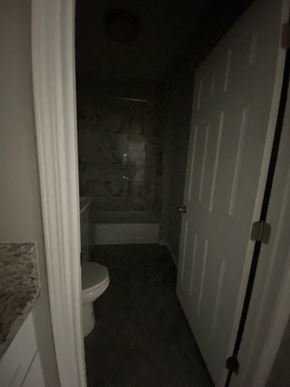 Colton apartment for rent - a bathroom with a toilet and a bath tub and a door