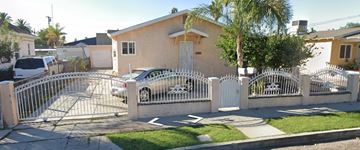 San Bernardino apartment for rent - a house with a car behind a white fence