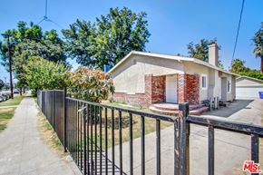 San Bernardino apartment for rent - a small house with a fence and a sidewalk in front of it