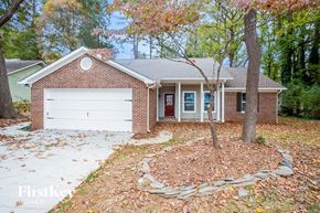 Mint Hill house for rent - A brick house with a white garage door and a red door.