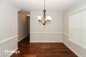 Arlington house for rent - a dining room with a large window and a chandelier