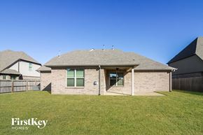 Arlington house for rent - a brick house with an open porch and a grass yard