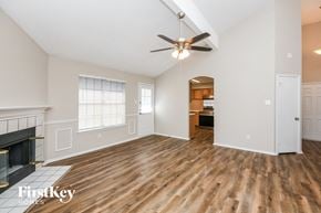 Mansfield house for rent - A spacious room with a fireplace and wood flooring.