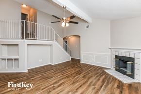 Mansfield house for rent - A spacious living room with a fireplace and a staircase.