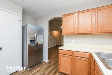 Mansfield house for rent - A kitchen with wooden cabinets and a stainless steel refrigerator.