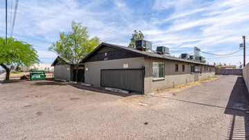Phoenix apartment for rent - a white and black building with a black garage door