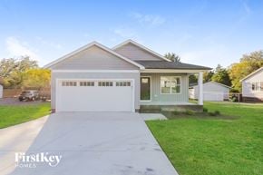 Kannapolis house for rent - a house with a white driveway and a green lawn