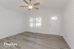 Kannapolis house for rent - a bedroom with white walls and a ceiling fan