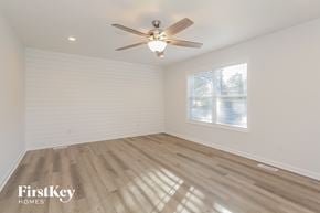 Kannapolis house for rent - a living room with wood floors and a ceiling fan