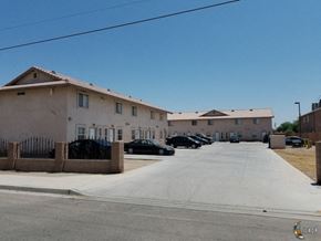 Seeley apartment for rent - a row of buildings with cars parked in front of them