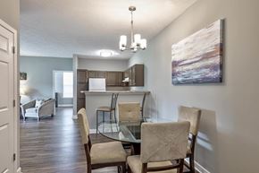 Evansville apartment for rent - a dining room with a glass table and chairs