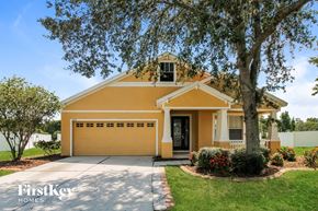 Wesley Chapel house for rent - A yellow house with a tree in front of it.