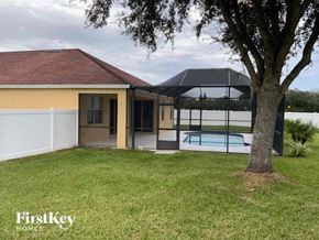 Wesley Chapel house for rent - A house with a pool and a tree in the front yard.