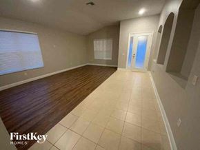Wesley Chapel house for rent - A room with wooden flooring and a white door.