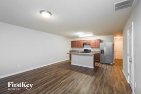 Conyers house for rent - A kitchen with wooden floors and white walls.