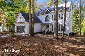 Charlotte house for rent - a white house in the woods with trees