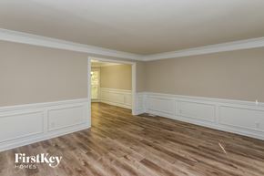 Charlotte house for rent - the living room of a house with wooden floors and white walls