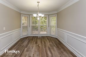 Charlotte house for rent - a dining room with wood flooring and a large window
