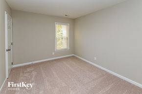 Charlotte house for rent - a bedroom with a carpeted floor and a window