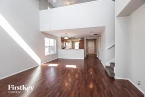 Fort Worth house for rent - A spacious room with wooden floors and white walls.
