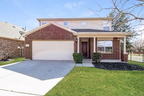 Fort Worth house for rent - A house with a brick facade and a white garage door.