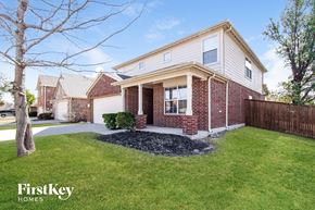 Fort Worth house for rent - A brick house with a white trim and a small front yard.