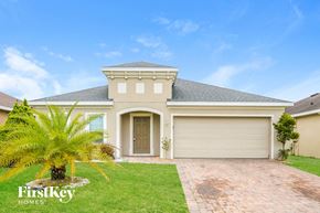 Kissimmee house for rent - a house with a palm tree in front of it