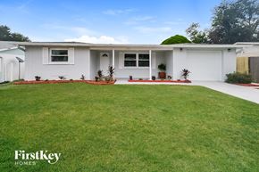 New Port Richey house for rent - a white house with a lawn in front of it