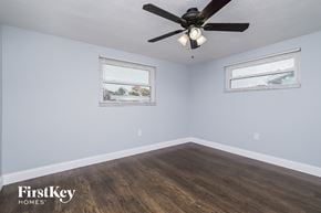 New Port Richey house for rent - the bedroom has a ceiling fan and hardwood floors