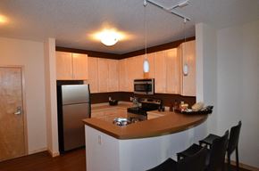 Minneapolis apartment for rent - A kitchen with a refrigerator, microwave, oven, and sink.