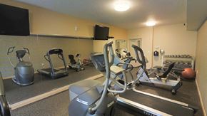 Minneapolis apartment for rent - A gym with elliptical machines and weights.