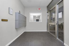 San Francisco apartment for rent - A white wall with a red exit sign on it.