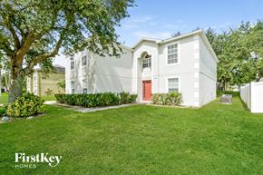 Apopka house for rent - a white house with a red door and a lawn