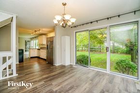 Hilliard house for rent - the living room and kitchen of a house with large sliding glass doors
