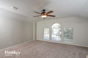 San Antonio house for rent - a living room with a ceiling fan and a window