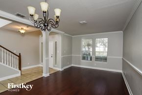 San Antonio house for rent - an empty living room with a chandelier and a window