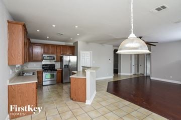 San Antonio house for rent - a kitchen with wooden cabinets and stainless steel appliances