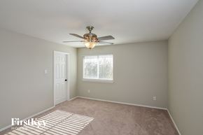 San Antonio house for rent - a bedroom with a ceiling fan and a window