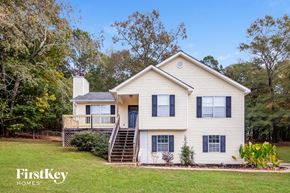 Newnan house for rent - a white house with a deck and a yard